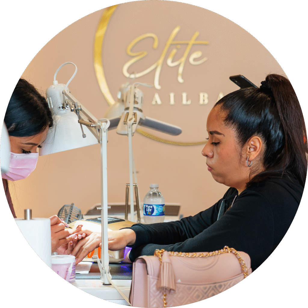 Tidy manicure work surfaces and comfortable guest seating at ELITE NAIL BAR AND SPA