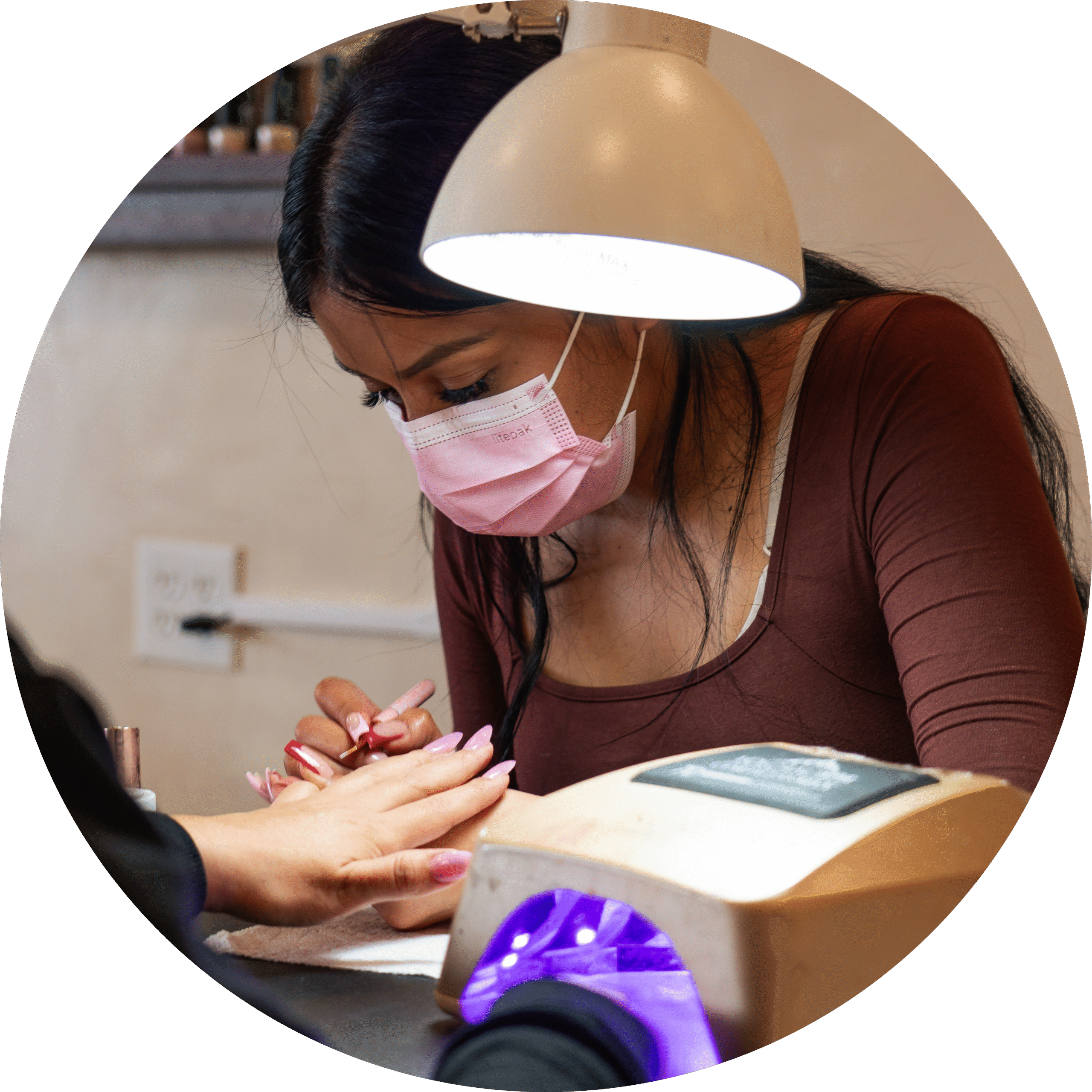 Skilled technician shaping and refining gel nails at ELITE NAIL BAR AND SPA
