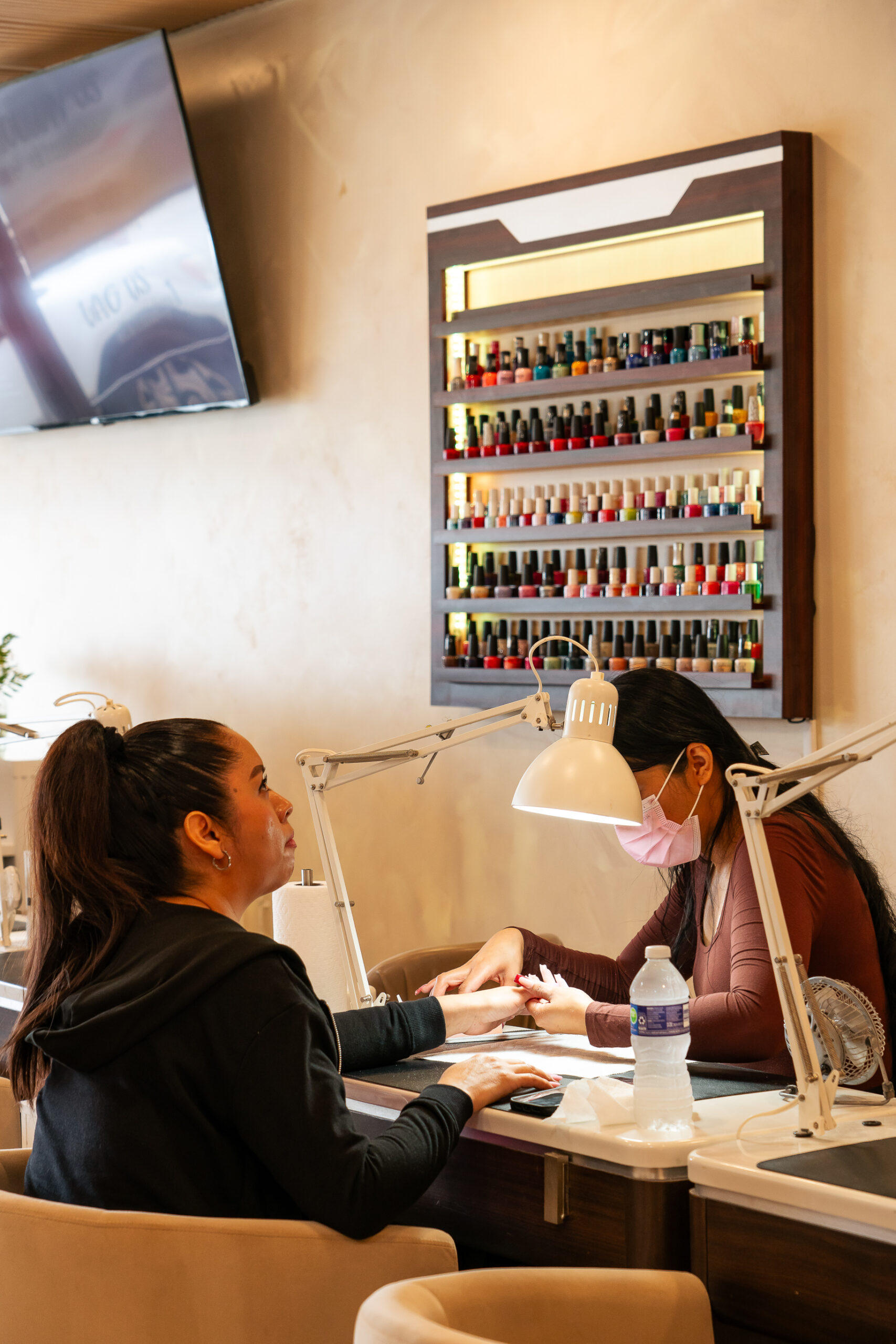 High-gloss chrome mirrored finish on tapered almond nails at ELITE NAIL BAR AND SPA